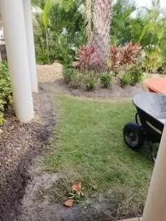 A freshly trenched bed edge with a wheelbarrow